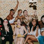 Joyful friends celebrating New Year's Eve at a festive indoor party, filled with laughter and fun.