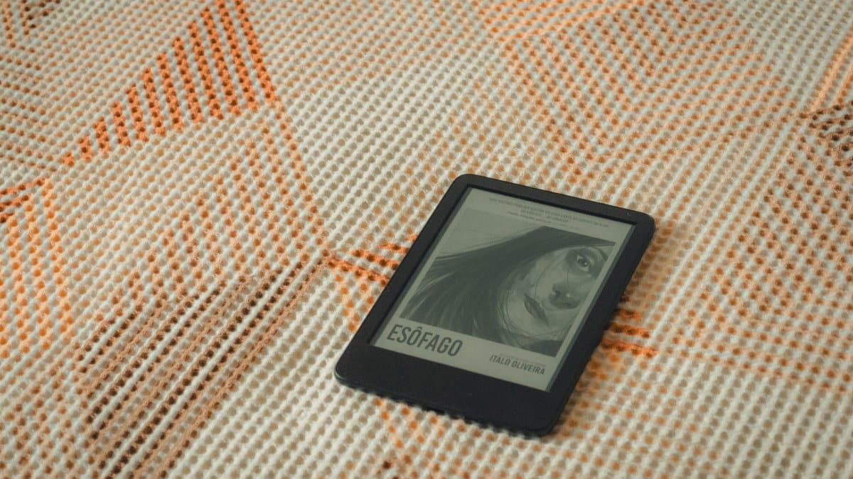 E-reader displaying a book cover on a patterned fabric for a cozy reading moment.