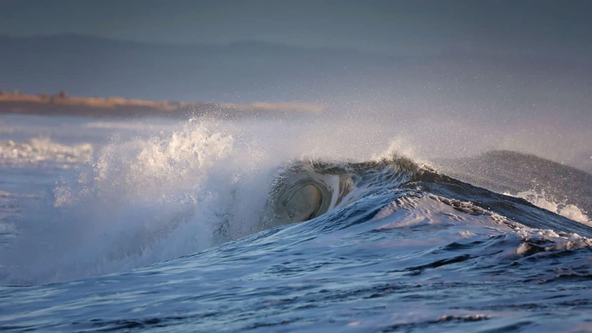 Dynamic ocean waves crash against the shore at Ocean Shores, WA, capturing nature's raw power.
