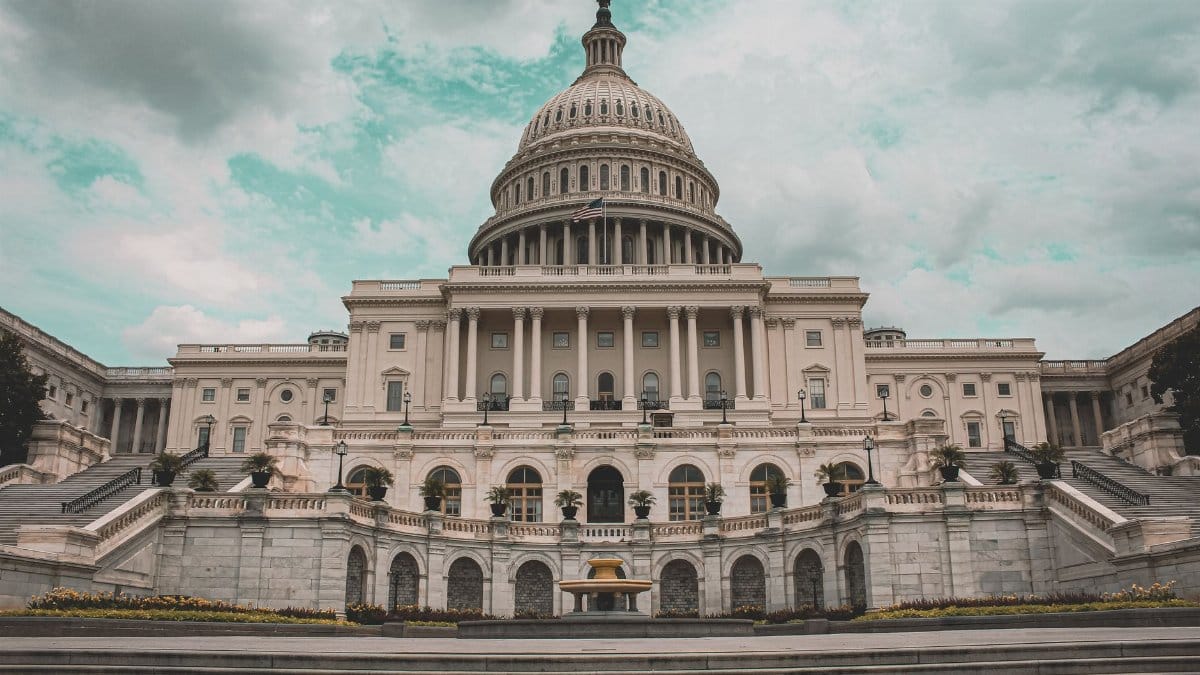A dramatic view of the United States Capitol with cloudy skies in Washington D.C.