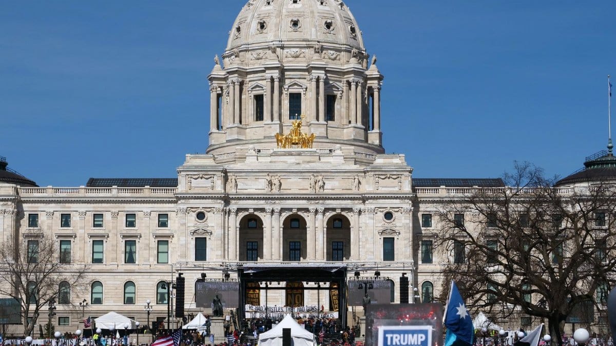 Crowd gathers at Minnesota State Capitol for protest in springtime.