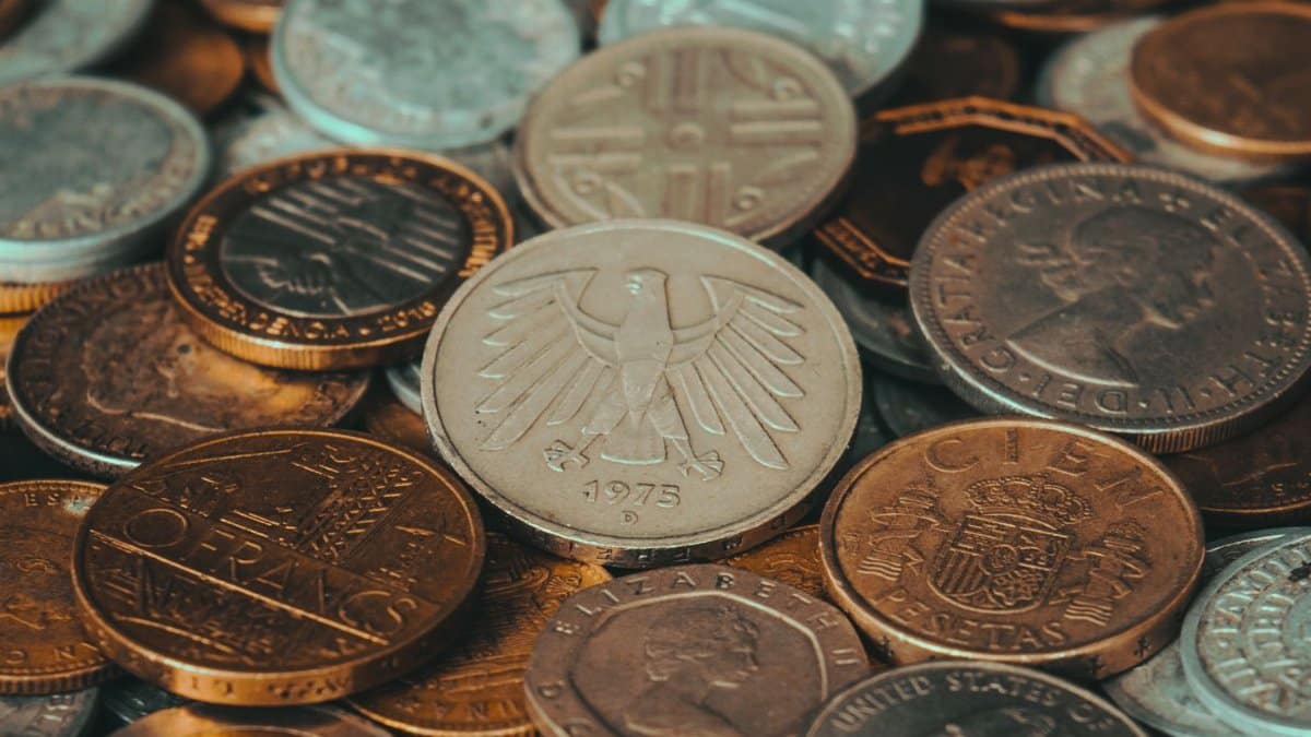 Close-up of various international coins, showcasing diverse currency designs and historical significance.