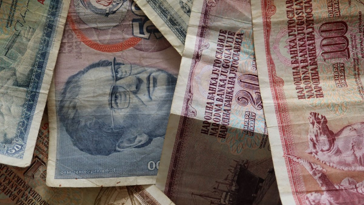A close-up photo of diverse vintage banknotes, showcasing historical currency from different countries.