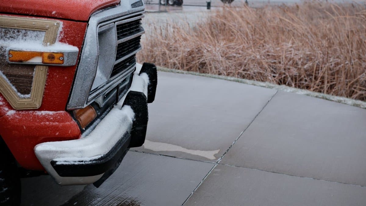 A retro vehicle dusted with snow on a snowy pavement in Pontiac, Illinois.