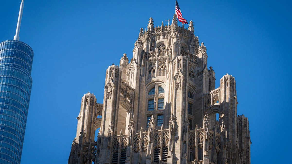 The historic Tribune Tower in Chicago, featuring its gothic architecture and American flag.