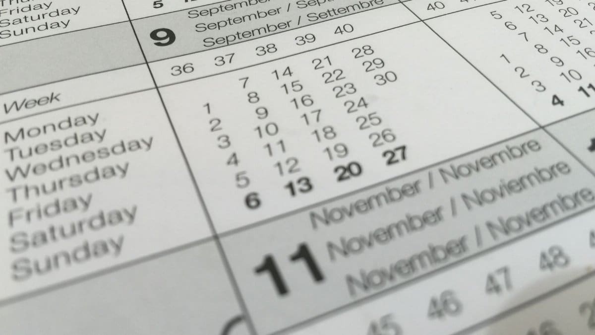 Detailed close-up of a calendar displaying months in several languages.
