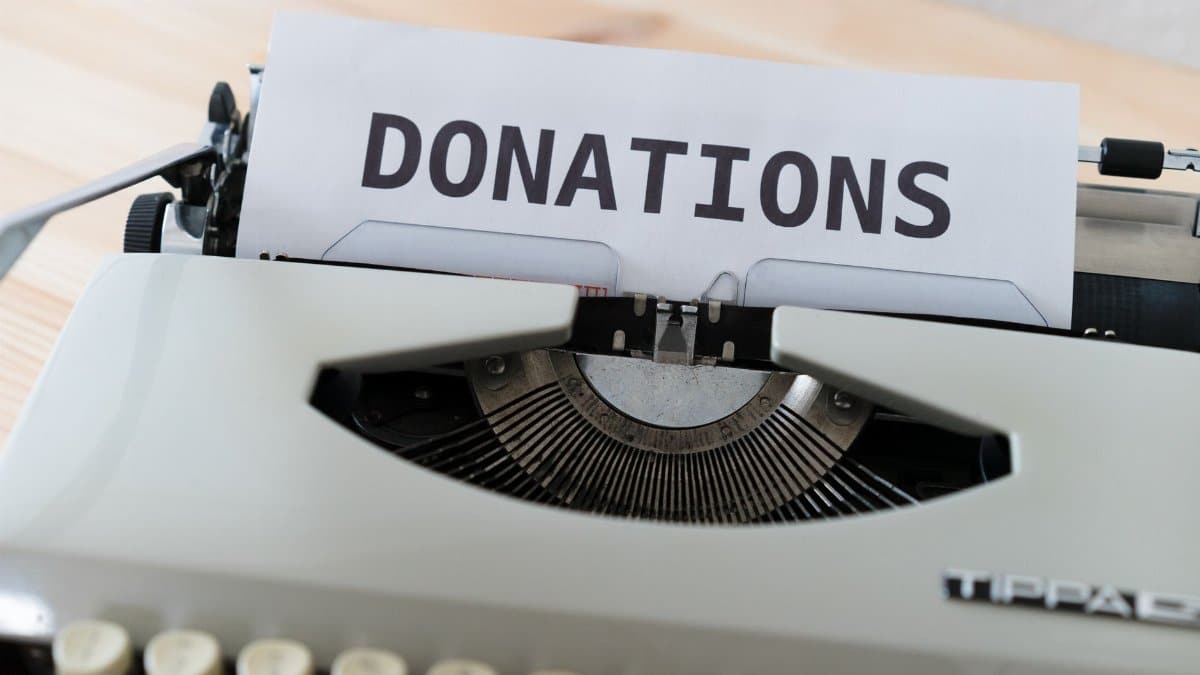 Close-up of a vintage typewriter with a paper displaying the word 'DONATIONS'.