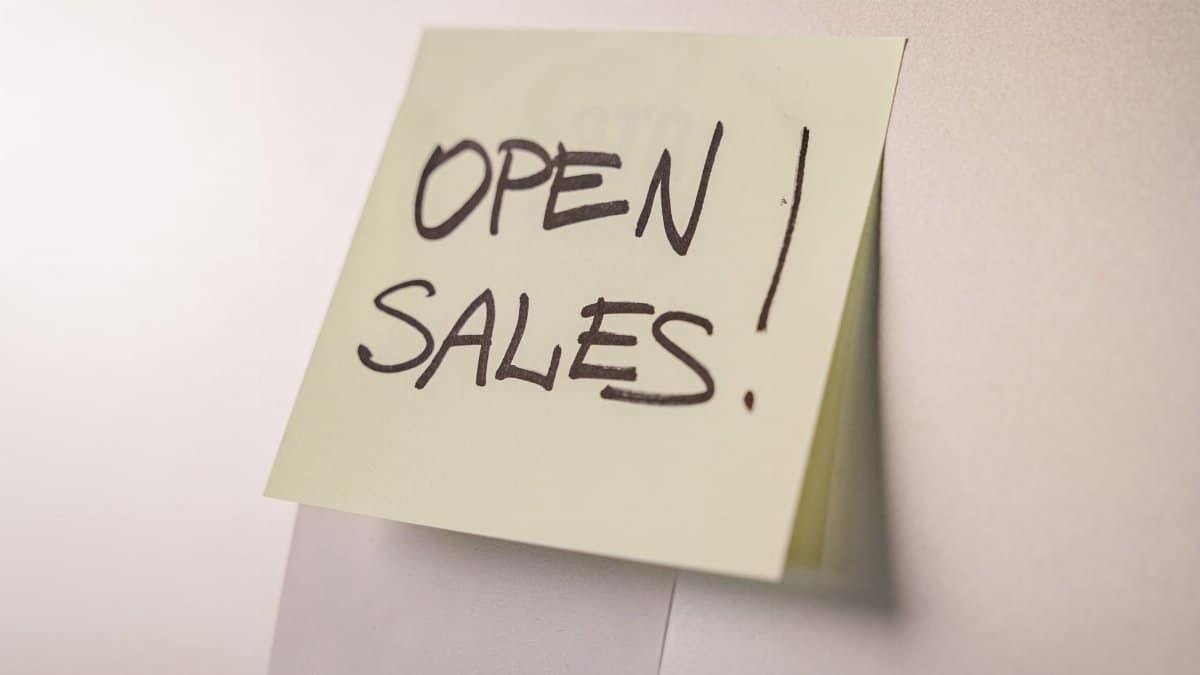 A close-up of an 'Open Sales' sticky note on a white background, ideal for business promotions.
