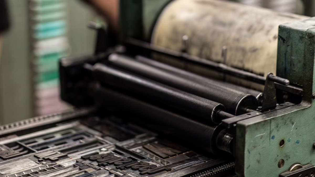 Detailed view of an industrial printing press with precise mechanics.