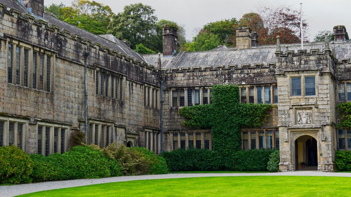 Exterior view of Lanhydrock House, a historic landmark in Cornwall, UK, showcasing its classic architecture.