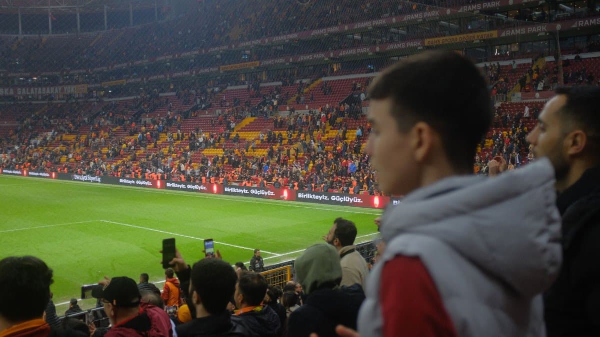 Crowd at a thrilling soccer match in Istanbul stadium with vibrant atmosphere.