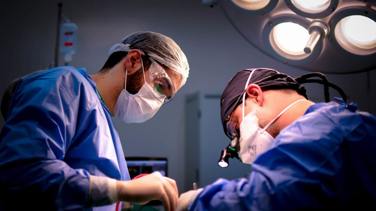 Focused surgeons performing a meticulous operation in a hospital operating room.