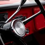 Close-up view of a classic Chevrolet steering wheel in a vintage red truck in Alto, Michigan.