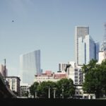 A view of the Houston skyline from a park, showcasing modern architecture under clear skies.
