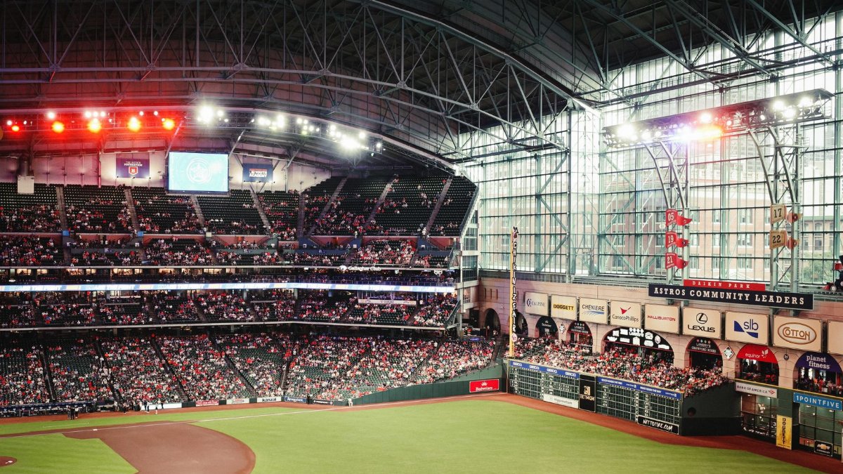 Exciting baseball game atmosphere at Minute Maid Park, Houston, with a large crowd enjoying the match.