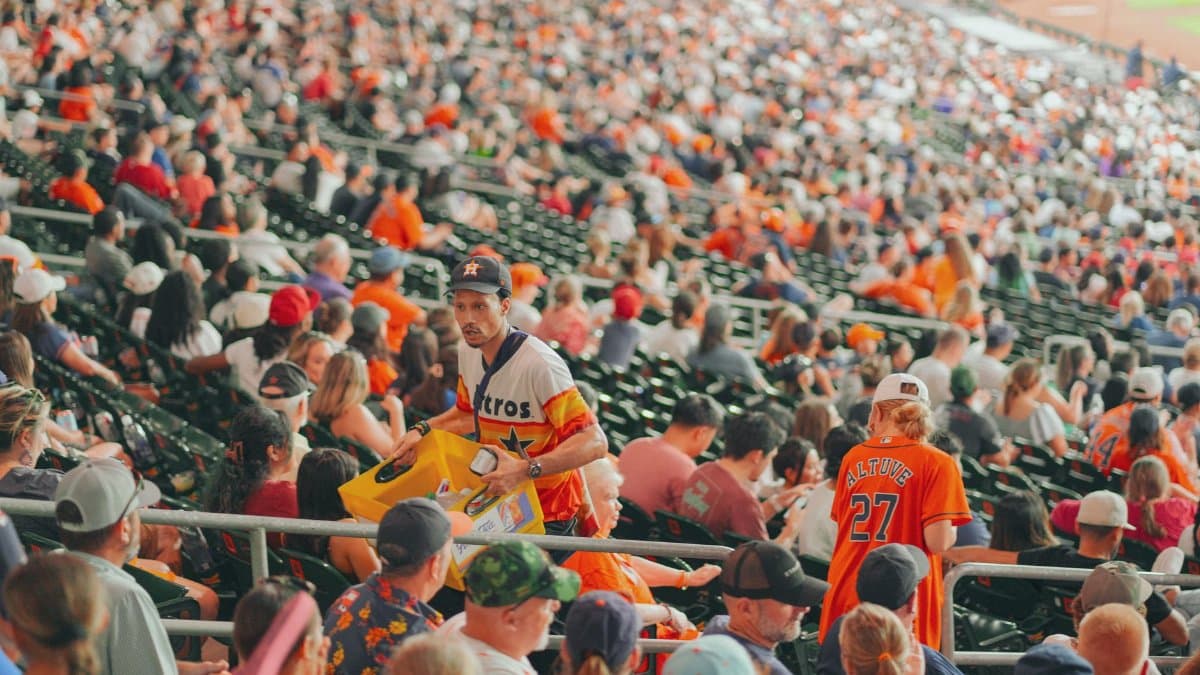 Packed Houston stadium featuring enthusiastic baseball fans during a major league game.