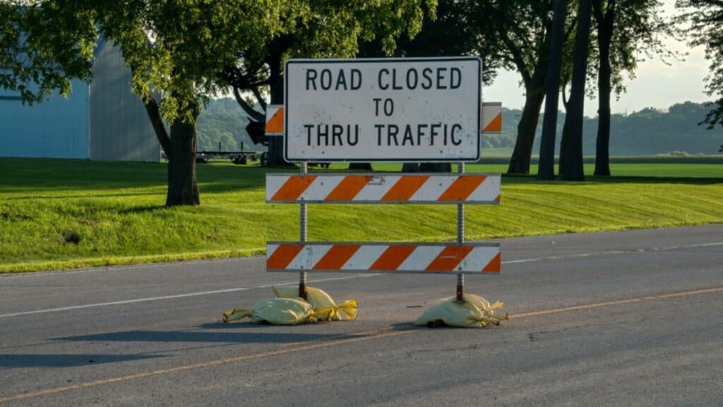 A road closure sign blocks traffic on a rural road in Plainview, Minnesota.