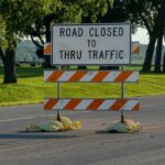 A road closure sign blocks traffic on a rural road in Plainview, Minnesota.