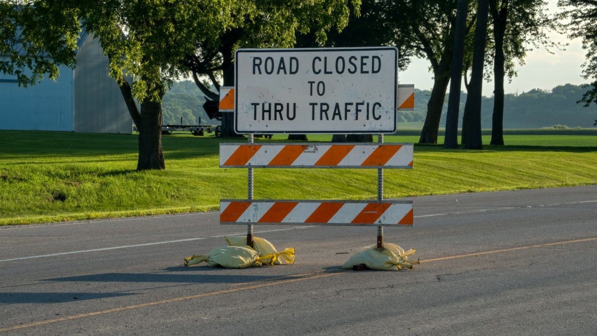 A road closure sign blocks traffic on a rural road in Plainview, Minnesota.
