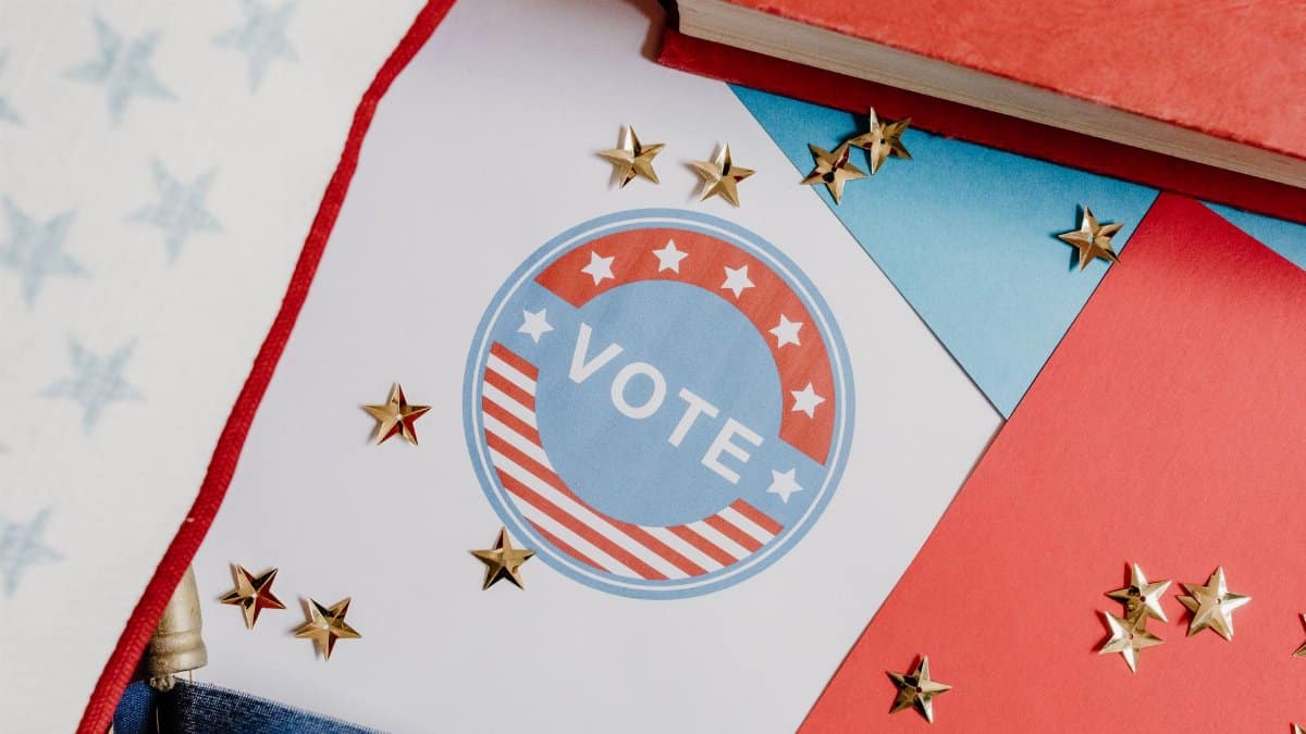 Flat lay of voting symbol with red, white, and blue colors and gold stars, symbolizing American democracy.