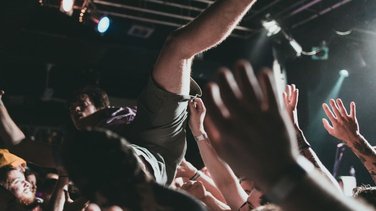 Vibrant scene of a crowd surfer at a live music concert, capturing the thrilling atmosphere.