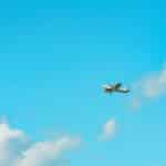 A small plane soaring through a clear blue sky over Stratford, Ontario, Canada.