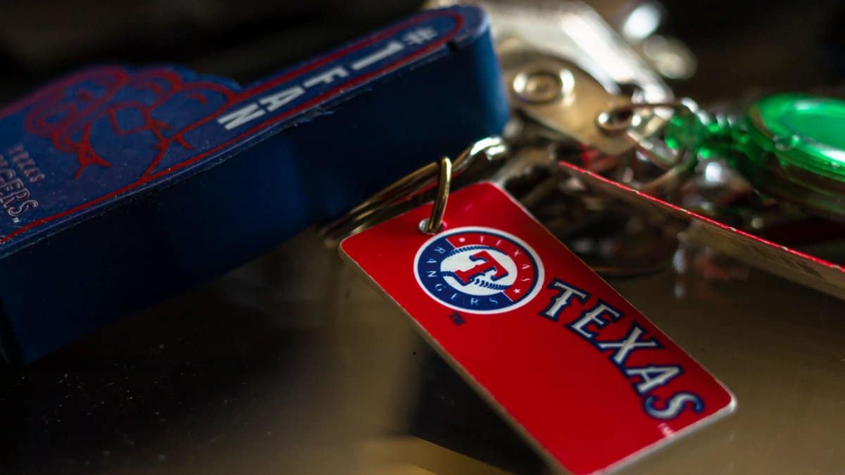 Detailed close-up of a Texas Rangers keychain featuring vibrant colors and logo.
