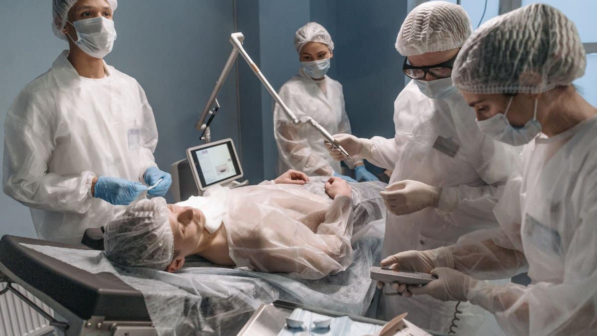 A surgical team works attentively on a patient in an operating room setting.