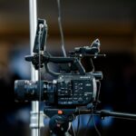 High-quality 4K video camera setup on a tripod indoors, perfect for event filming.