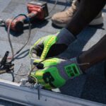 Technician installing solar panels on a roof in Tampa, showcasing clean energy efforts.