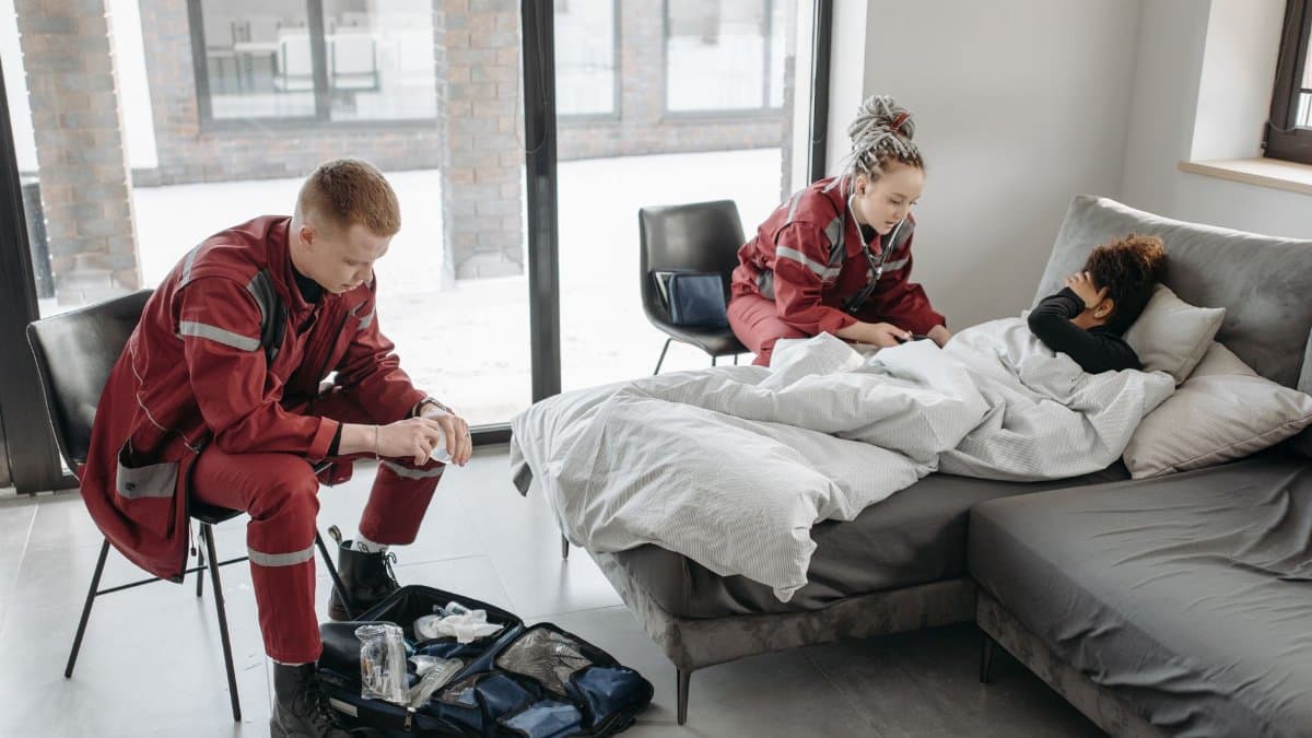 Emergency medical responders attending to a sick patient at home, emphasizing healthcare and urgent assistance.