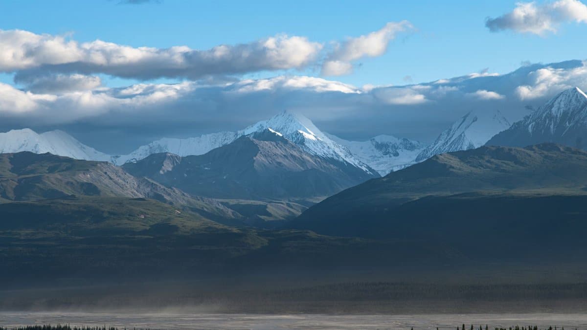Breathtaking view of Alaska's snow-capped mountains under a clear sky. Perfect for travel inspiration.