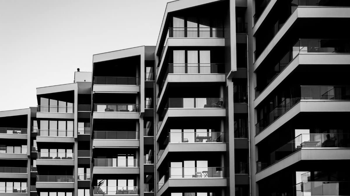 Striking black and white photo of a modern apartment building facade with geometric design.