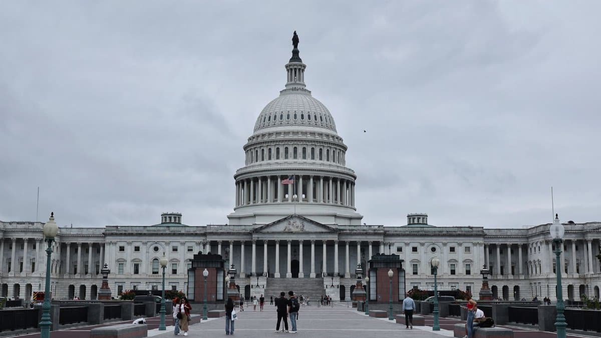 A grand shot of the United States Capitol in Washington D.C. with visitors in the foreground.