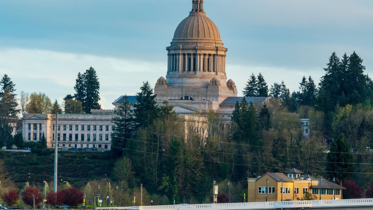 Scenic view of the Washington State Capitol building in Olympia surrounded by lush greenery.