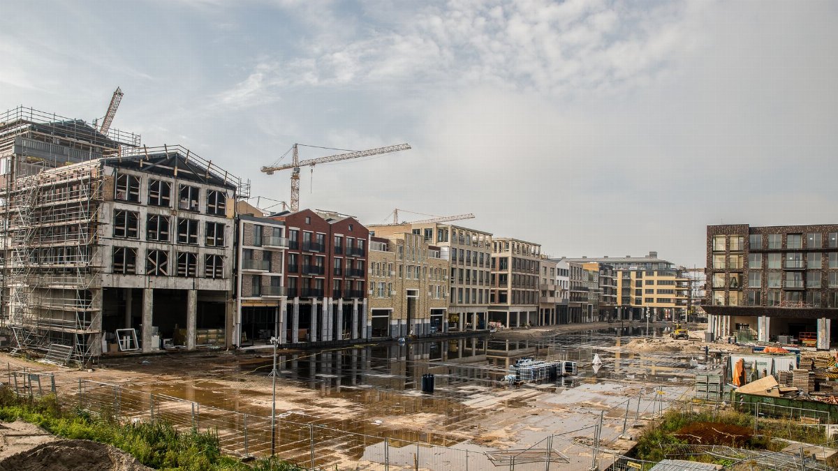 A modern construction site with buildings and cranes showcasing urban development.