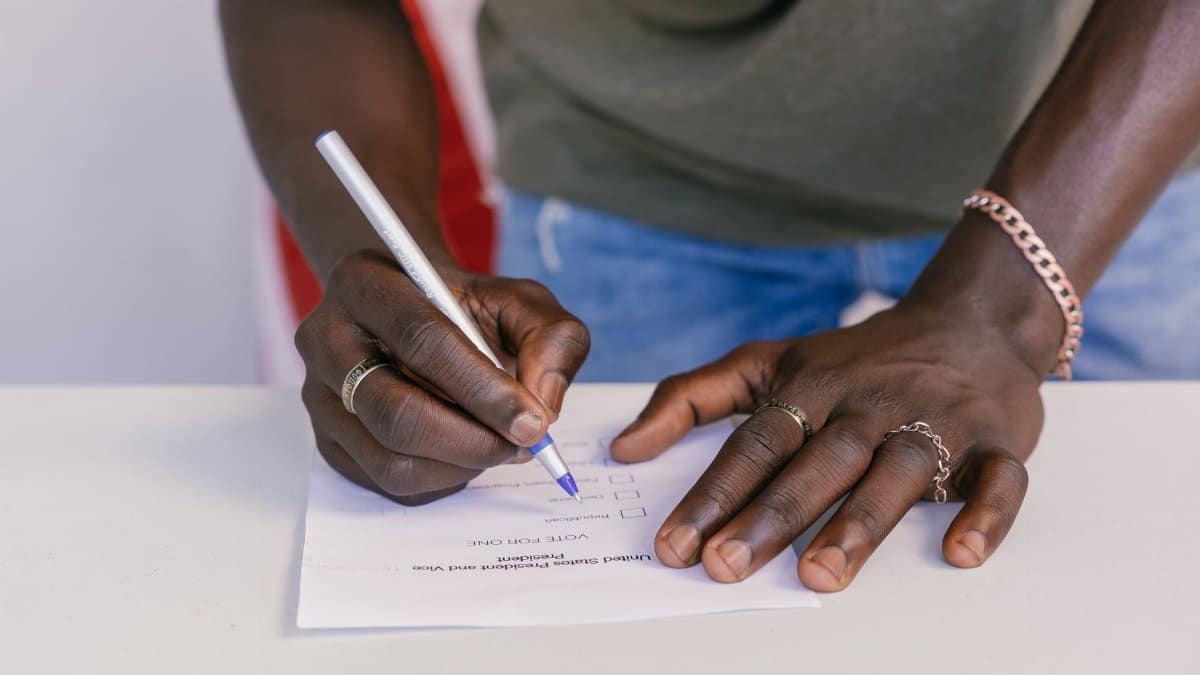 A close-up of a person marking a ballot paper during an election.