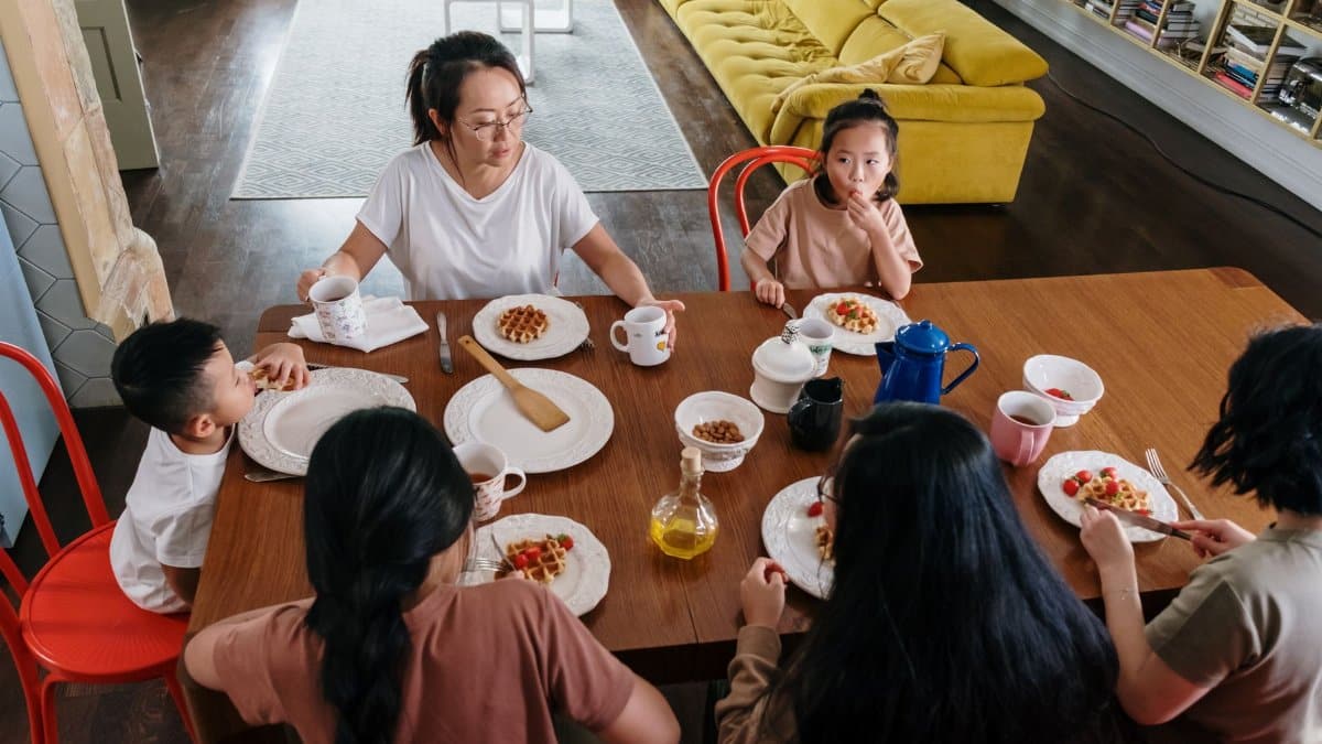 Asian family enjoying breakfast together in a cozy home, fostering togetherness and bonding.