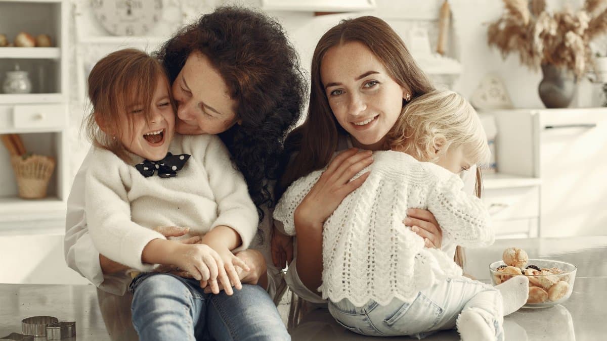 A joyful family gathering in a cozy kitchen with three generations bonded in happiness.