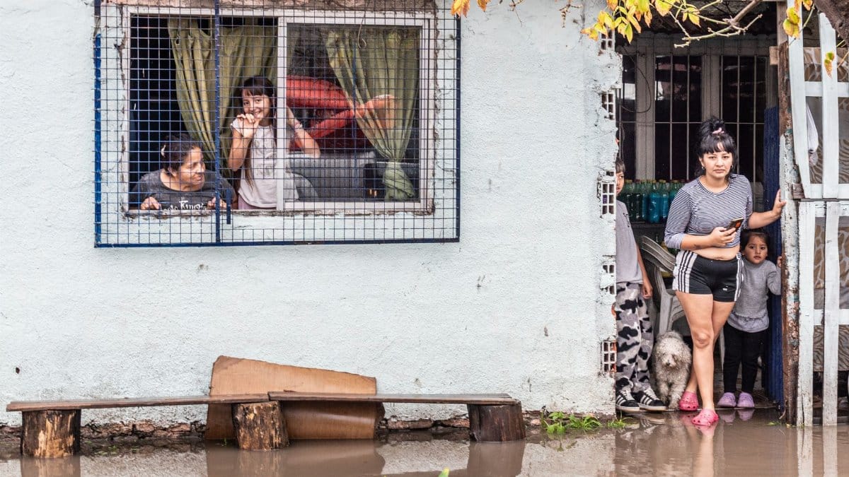 Families coping with flooding in Buenos Aires, reflecting climate impact.