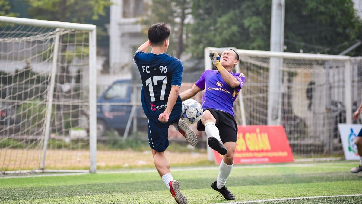 Exciting moment captured between two soccer players during a game in Hà Nội, Vietnam.