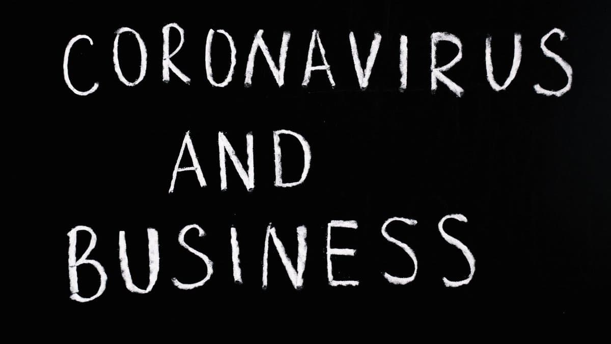 Chalkboard with 'Coronavirus and Business' written on it, illustrating COVID-19 impact.
