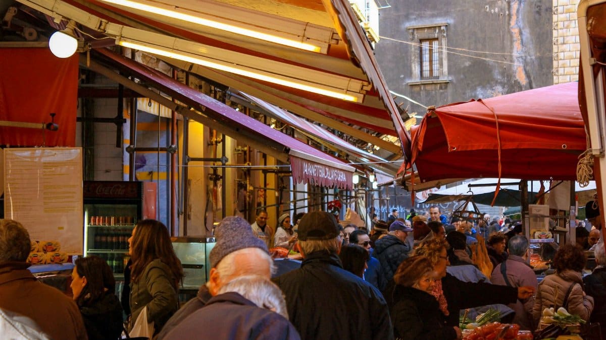 Experience the bustling street market in Catania, Sicily, full of local flavor and culture.