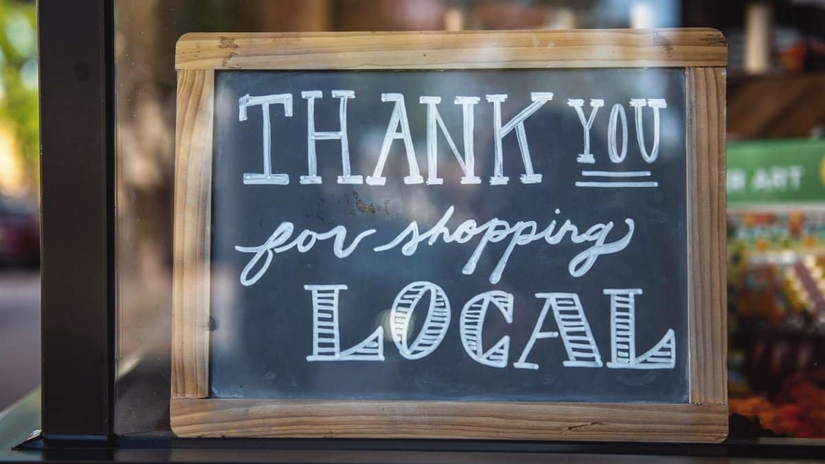 Chalkboard sign encourages shopping local in San Luis Obispo store.