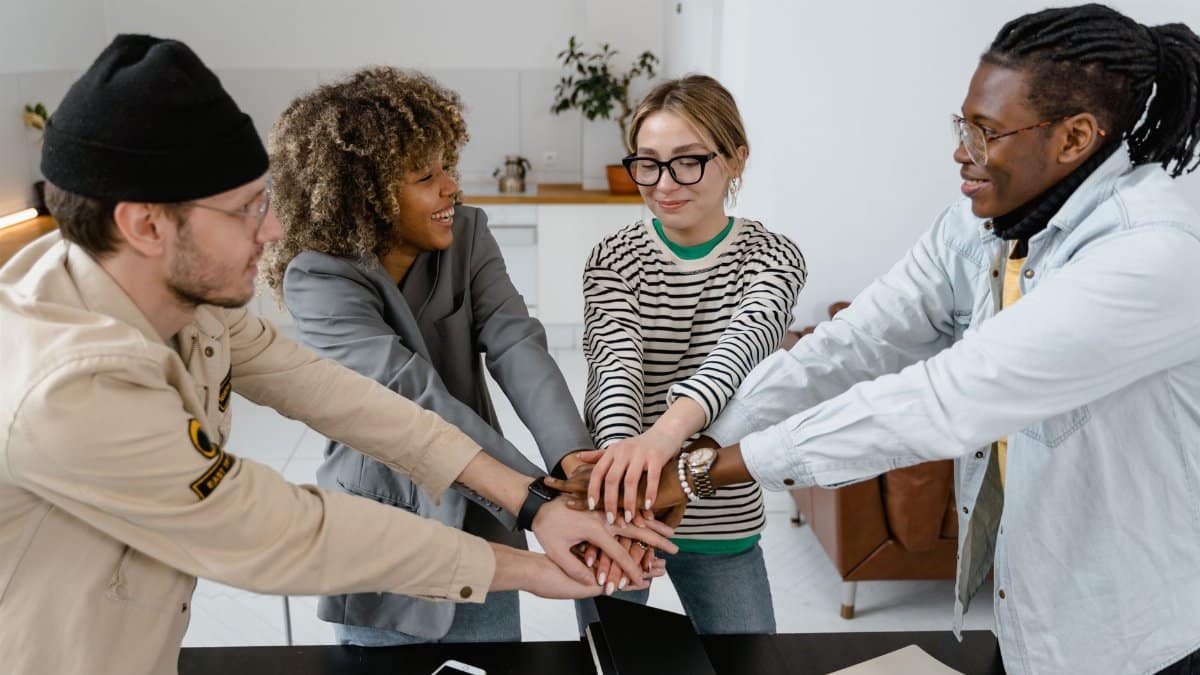 A diverse group of office co-workers sharing a team bonding moment.