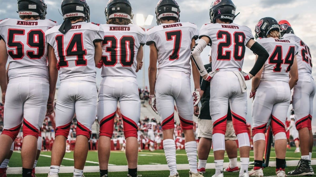 High school football team standing on the field ready for the game.