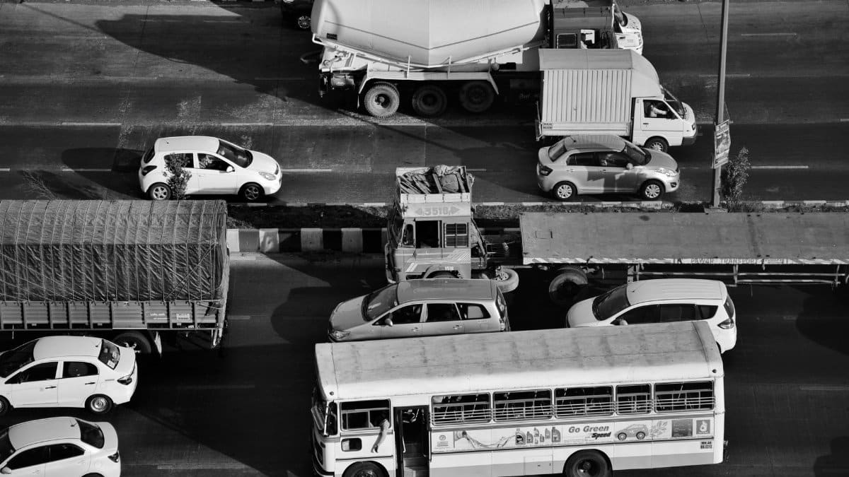 Aerial photograph captures traffic congestion on Mumbai road in black and white, showcasing urban life.