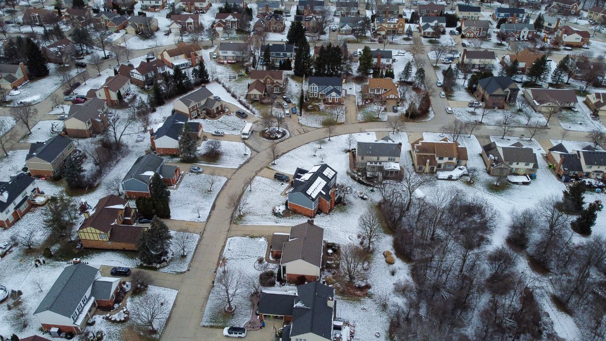 Aerial photograph of a snow-dusted suburban neighborhood in Novi, Michigan, during winter.