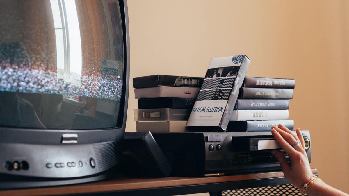 Vintage scene with a VHS player, tapes, and an old CRT TV creating a nostalgic vibe.