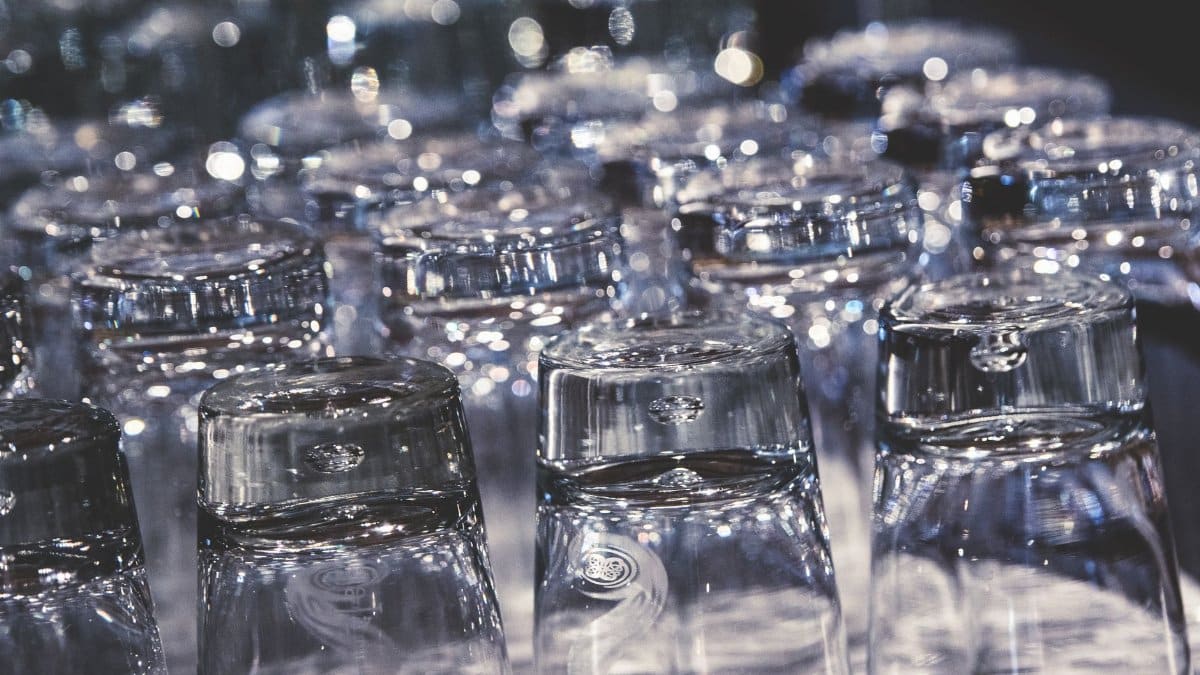 Close-up of crystal clear upside-down drinking glasses with an elegant reflection.